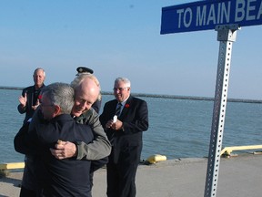 Dr. John Hofhuis embraces Elgin county warden and Central Elgin Deputy Mayor David Marr at a ceremony that announced plans for a new park off Port Stanley's west breakwater. Hofhuis Park is named in honour of John and Sylvia Hofhuis for their contributions to the Central Elgin community. John has been serving the community as a family physician for over 35 years and Sylvia is a former Central Elgin mayor who passed away after a battle with cancer in 2010. (Ben Forrest, Times-Journal)