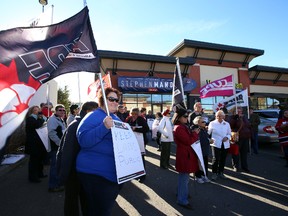 AUPE and Friends of Medicare rally outside of Stephen Mandel's campaign office in Riverbend in Edmonton, Alberta on Friday, October 24, 2014.  The noon rally hope to reject the health lab deal. Perry Mah/Edmonton Sun