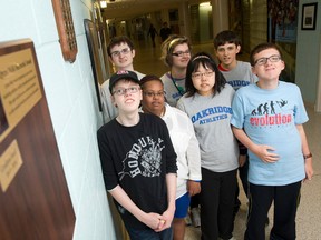 Students from a developmental class stand beside a plaque in a hallway at Oakridge secondary school in memory of former student Qyzra Walji. A $200 annual award in her honour recognizes a student in the developmental class who shows leadership and advocates for others. Qyzra and her mother were shot to death in their London home by Mohamed Walji, who then killed himself. (CRAIG GLOVER, The London Free Press)