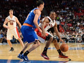 Raptors guard Kyle Lowry (right) dribbles the ball as Knicks guard Pablo Prigioni defends in Montreal last night. (USA Today)