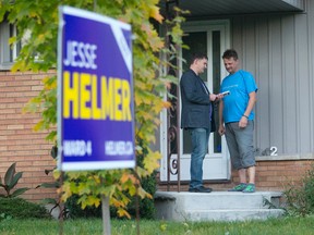 Candidate Jesse Helmer talks with McNay St. resident Kevin Swalwell while canvassing in Ward 4, one of several races where incumbents could fall. (CRAIG GLOVER, The London Free Press)