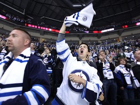 Chad Kendel celebrates a first-period goal from Jets centre Mark Scheifele against the Flames during NHL action at MTS Centre in Winnipeg on Sunday, Oct. 19, 2014. (Kevin King/Winnipeg Sun)