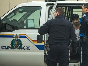 Associated Ambulance EMS personnel check on Craig Benson, 38, who was arrested after a 911 complaint for a possible overdose lead to his arrest. Benson will be in Whitecourt Provincial court on Oct. 28, 2014 facing 13 charges including possession and trafficking of marijuana, methamphetamine and crack cocaine. 
Christopher King | Whitecourt Star