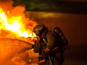 Whitecourt fire and RCMP responded to a vehicle fire behind the IGA in downtown Whitecourt, Alta. just before 5 a.m. on Monday, Aug. 20, 2014. No one appeared to be in the vehicle and the fire was quickly extinguished by Whitecourt firefighters. ADAM DIETRICH/WHITECOURT STAR/QMI AGENCY