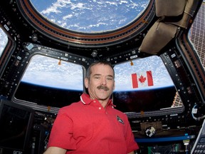 Chris Hadfield, shown on the International Space Station, has released a new book of photos of the Earth taken from space. You Are Here, Around the World in 92 Minutes, includes more than 100 photos Hadfield shot from space while he lived and worked for five months on the space station. NASA PHOTO