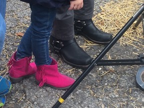 John Tory's motorcycle boots on Oct. 25, 2014. The pink boots belong to his granddaughter Isabel. (Don Peat/Toronto Sun)