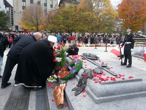 Two dozen Muslims, led by Sheikh Salman Al-Abidi, placed an arrangement of red roses directly on the Tomb of the Unknown Soldier, Saturday, Oct. 25, 2014, paying respect to Cpl. Nathan Cirillo, gunned down in an Oct. 22 terror attack while standing sentry. “Terrorism has no religion,” he said through translator Biraq Hussein from Ottawa's Al Mahdi Centre. 
KELLY ROCHE/OTTAWA SUN/QMI AGENCY