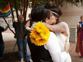 Amanda Scott (R) and Christina Corvin (L) kiss after getting married outside of the Mecklenburg County Register of Deeds office in Charlotte, North Carolina, October 13, 2014. (REUTERS/Davis Turner)