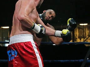 Heavyweight Dillon Carman (left) knocks out Eric Martel Bahoeli in teh seventh round at the Mattamy Athletic Centre on Saturday. (Michael Peake/Toronto Sun)