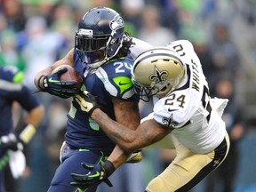 Seattle Seahawks running back Marshawn Lynch scores a touchdown against New Orleans Saints cornerback Corey White during the first half of the 2013 NFC divisional playoff football game at CenturyLink Field on January 11, 2014. (Steven Bisig/USA TODAY Sports)