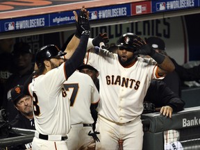 San Francisco Giants pinch-hitter Michael Morse (38) celebrates with third baseman Pablo Sandoval (right) after scoring a run against the Kansas City Royals in the seventh inning during Game 4 of the 2014 World Series at AT&T Park. (USA Today Sports)