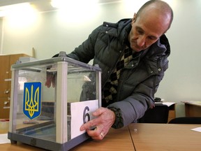 An election commission worker adjusts a number on a ballot box at a polling station in Kiev, October 25, 2014. (REUTERS/Valentyn Ogirenko)