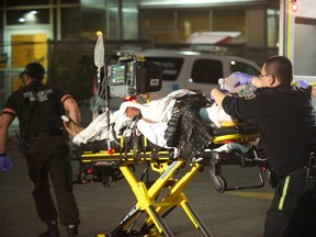 Paramedics rush a man who suffered critical injuries in a double stabbing at Canada's Wonderland to Sunnybrook hospital Sunday, Oct. 26, 2014. (VICTOR BIRO/Special to the Toronto Sun)