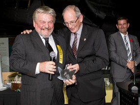 Peter May, left, who founded Research Casting International Ltd. in 1987, is Quinte's business person of the year. May, received the 2014 Quinte Business Achievement Award from Glenn Kozak of Trenval at the 17th annual award ceremony held at the National Air Force Museum of Canada in Trenton, Ont. Friday night, Oct. 24, 2014. - Photo by Mike Gaudaur