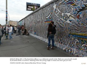 The East Side Gallery is a 1.3-km stretch of the Berlin Wall now covered with murals by 118 artists from 21 countries. Standing where the young couple is would once have got you shot. JOHN MASTERS/MERIDIAN WRITERS' GROUP