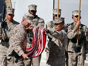 U.S. Marines stand at attention during a handover ceremony, as the last U.S. Marines unit and British combat troops end their Afghan operations, in Helmand October 26, 2014. The last U.S. Marines unit and final British combat troops in Afghanistan officially ended their operations on Sunday as they packed up to leave the country and transferred a massive military base to the Afghan military. REUTERS/Omar Sobhani