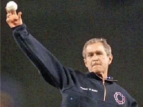 Amidst heavy security, then-president George W. Bush throws out the first pitch at Yankee Stadium prior to a World Series game, 49 days after 9/11. (AFP)