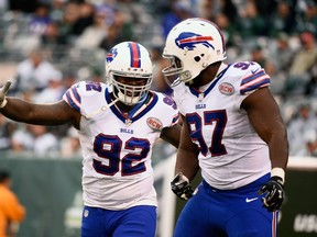 Jarius Wynn #92 of the Buffalo Bills celebrates with teammate Corbin Bryant #97 after sacking quarterback Michael Vick #1 of the New York Jets in the fourth quarter at MetLife Stadium on October 26, 2014 in East Rutherford, New Jersey. (Alex Goodlett/Getty Images/AFP)