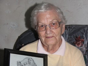 Retired Sarnia nurse Virginia Schramek holds up a portrait of her late husband Edward sketched during his time at the Dachau concentration camp during World War II. Edward remarkably survived two years as a prisoner of war and returned home to marry Virginia who had served with the Canadian Women's Army Corps. BARBARA SIMPSON/THE OBSERVER/QMI AGENCY