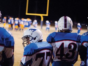 Mustang players look on as their defence tries to stop the Cobras from scoring in the first half of their playoff game in Claresholm. Greg Cowan photo/QMI Agency.