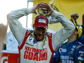 Dale Earnhardt Jr., driver of the #88 National Guard Chevrolet, celebrates in Victory Lane after winning the NASCAR Sprint Cup Series Goody’s Headache Relief Shot 500 at Martinsville Speedway yesterday. (AFP)