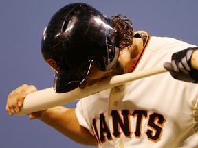 Madison Bumgarner of the San Francisco Giants bites his bat after striking out to end the fourth inning against the Kansas City Royals during Game 5 of the 2014 World Series on Sunday night. (AFP)