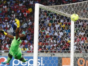 Goalkeeper Senzo Meyiwa of South Africa's Orlando Pirates fails to save a goal by Mohamed Aboutrika of Egypt's Al Ahli during the first leg of their African Champions League final soccer match at Orlando Stadium in Soweto, in this November 2, 2013 file picture. REUTERS/Siphiwe Sibeko/Files