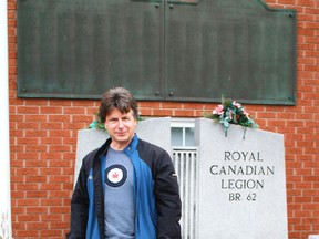 Author Tom Slater stands in front of Branch 62 of the Royal Canadian Legion on Front Street North in Sarnia. Slater is releasing a book commemorating and honouring Sarnia's fallen soldiers of wars past and present. The plaques on the Legion's walls were originally part of Sarnia's cenotaph, a memorial to soldiers killed overseas. (CARL HNATYSHYN, QMI Agency)