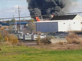 Flames and smoke rage out the roof of a building at the edge of an industrial area just outside Vars on Monday. (JESSE WHYTE Submited image)