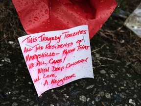 A note on a bouquet of flowers gets wet in the rain at a makeshift memorial outside Marysville-Pilchuck High School the day after a school shooting in Marysville, Washington October 25, 2014. Relatives of a Washington state teen accused of a high school shooting rampage said on Saturday that they were living in a "nightmare" and struggling to understand why the boy targeted his two cousins and several friends before killing himself. One girl was killed and four other freshman students were severely wounded in Friday's morning rampage inside the cafeteria at Marysville-Pilchuck High School, north of Seattle. REUTERS/Jason Redmond