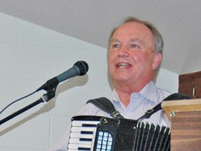 Bob Heywood, of Exeter, entertained guests and members of OPAL at their 22nd anniversary dinner last Wednesday, Oct. 22 at the Mitchell & District Community Centre. Heywood shared stories and performed Canadian folk music for the event.  KRISTINE JEAN/MITCHELL ADVOCATE