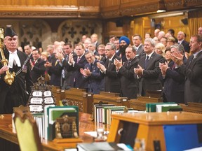 House of Commons sergeant-at-arms Kevin Vickers is applauded by MPs on Thursday, Oct. 23. Vickers is credited with stopping gunman Michael Zehaf-Bibeau after a gun battle had erupted within Parliament’s halls the day before. Prior to getting into Parliament, Zehaf-Bibeau shot and killed Cpl. Nathan Cirillo at the National War Memorial. Photo Courtesy Jason Ransom