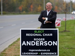Roger Anderson, standing by one of his election signs in Ajax earlier this month, was victorious as the first elected chairman of Durham Region. (Craig Robertson/Toronto Sun)