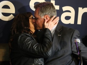 Mark Taylor celebrates his narrow victory with a big kiss for his wife Christine. DOUG HEMPSTEAD/Ottawa Sun