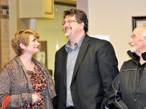 Prescott Mayor Brett Todd, centre, smiles with his wife Lori and resident David Cromb at town hall Monday after it became clear Todd was voted in for a second term as head of council (NICK GARDINER/The Recorder and Times).