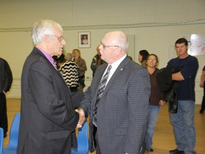Pembroke mayor elect Michael LeMay is congratulated by outgoing mayor Ed Jacyno at the conclution of Monday's municipal election.