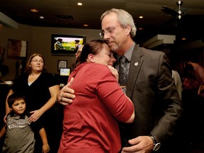 Mayor Randy Hope gets an emotional embrace from daughter Melissa after he is declared the winner of Chatham-Kent mayoral election, earning a third term Monday night. (Diana Martin/QMI Agency)