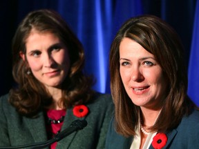 Wildrose leader Danielle Smith with candidates L-R,  Sheila Taylor and John Fletcher speak to media after losing their riding at Wildrose headquarters in Calgary, Alta. on Monday October27, 2014. Darren Makowichuk/Calgary Sun/QMI Agency