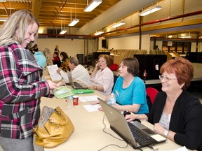 Julie Jacques-Barr registers to vote for the 2014 Municipal Election on Monday Oct. 27th with Election Offical Corinnne Breathat at the Tim Horton Event's Centre.