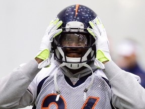 Denver Broncos cornerback Champ Bailey adjusts his helmet during their practice session for the Super Bowl at the New York Jets Training Center in Florham Park, New Jersey January 31, 2014.    REUTERS/Ray Stubblebine (UNITED STATES - Tags: SPORT FOOTBALL)