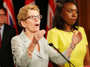 Ontario Premier Kathleen Wynne (centre) announces details of the planned Ontario Retirement Pension Plan. At right is Associate Finance Minister Mitzie Hunter, who is overseeing the implementation of the new pension plan which the province launched after failing to convince the federal government to expand the Canada Pension Plan. QMI Agency file photo