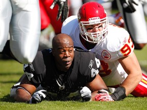 Oakland Raiders safety Chinedum Ndukwe loses his helmet after getting hit by the Kansas City Chiefs’ Cory Greenwood during an NFL game in Oakland in October 2011. (REUTERS file photo)