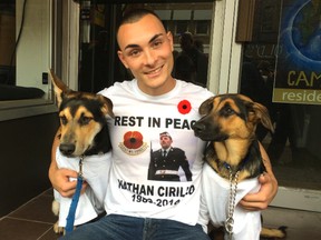 Karic Francella, 22, and his dogs — King (L) and Rose (R) — wear T-shirts that are being sold to raise money for his friend Cpl. Nathan Cirillo's young son. (CHRIS DOUCETTE/TORONTO SUN)
