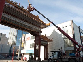 A crew from Alberta Neon worked on the Chinatown sign at 97 Street and 102 Avenue in Edmonton, Alberta, on Feb. 15, 2012. Edmonton City Council passed a light rail transit plan that would see trains run near the entrance to Edmonton's Chinatown. IAN KUCERAK/EDMONTON SUN