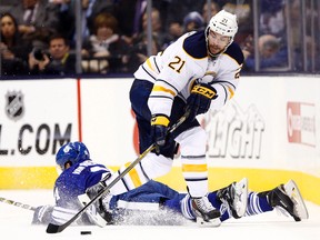 James van Riemsdyk of the Toronto Maple Leafs gets tripped by Drew Stafford of the Buffalo Sabres during NHL action on Oct. 28. (Dave Abel, Toronto Sun)