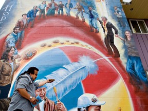 Gary Moostoos smudges during the unveiling of a mural along 95 Street near 107 Avenue honouring Hope Hunter, the former Executive Director of Boyle Street Community Services. (EDMONTON SUN FILE)