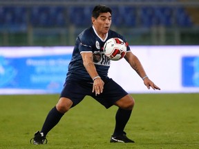 Former soccer star Diego Maradona controls the ball during a special interreligious "Match for Peace" at the Olympic stadium in Rome September 1, 2014.  REUTERS/Alessandro Bianchi