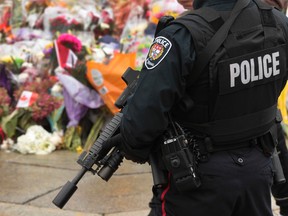 Ottawa police officers watched over the Royal Canadian Regiment at the National War Monument  in Ottawa Tuesday Oct 28,  2014.   Tony Caldwell/Ottawa Sun/QMI Agency