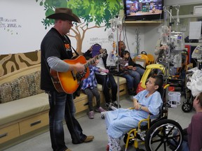 On an Oct. 26, 2013, visit to London, Alberta country star Gord Bamford played an informal set for kids, families and staff at the Children?s Hospital at London Health Sciences Centre and donated$10,000 to the Children?s Health Foundation to the hospital?s art therapy program (JAMES REANEY, The London Free Press)