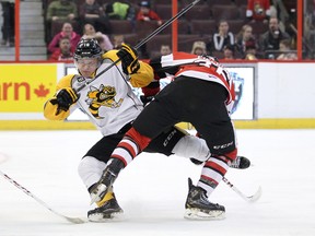 Sarnia's Davis Brown collides with Taylor Fielding, of the Ottawa 67's, in this photo from a matchup last season. Brown, a veteran Sting forward, may get the chance to take fellow Sting member Jordan Kyrou's spot in Thursday's upcoming game with the Barrie Colts. Both Kyrou and defenceman Jakob Chychrun will be participating in the World U-17 Hockey Challenge starting this Friday. (File photo)